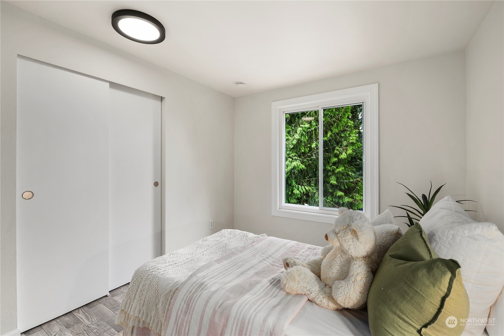 23019 20th Avenue Southeast Bothell, WA 98021 - Photo 17 of 34 a bed sitting in a bedroom next to a window