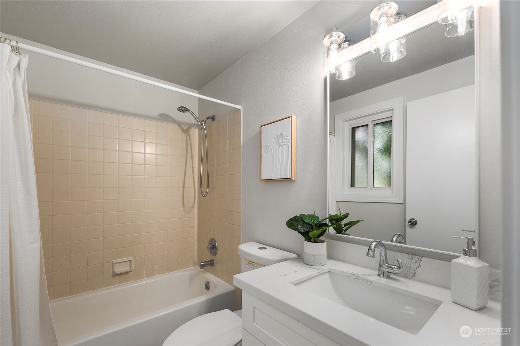 23019 20th Avenue Southeast Bothell, WA 98021 - Photo 21 of 34 a bathroom with a granite countertop sink a mirror and a bathtub
