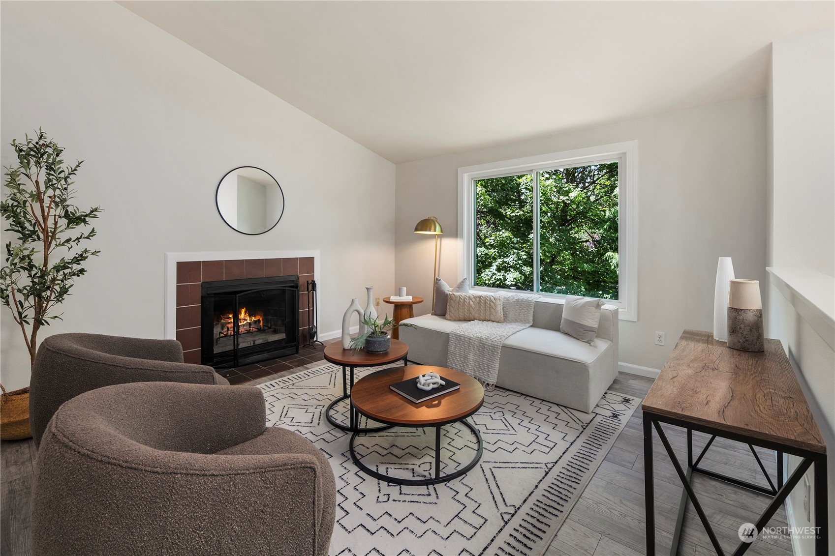 23019 20th Avenue Southeast Bothell, WA 98021 - Photo 5 of 34 a living room with furniture a rug a fireplace and a large window