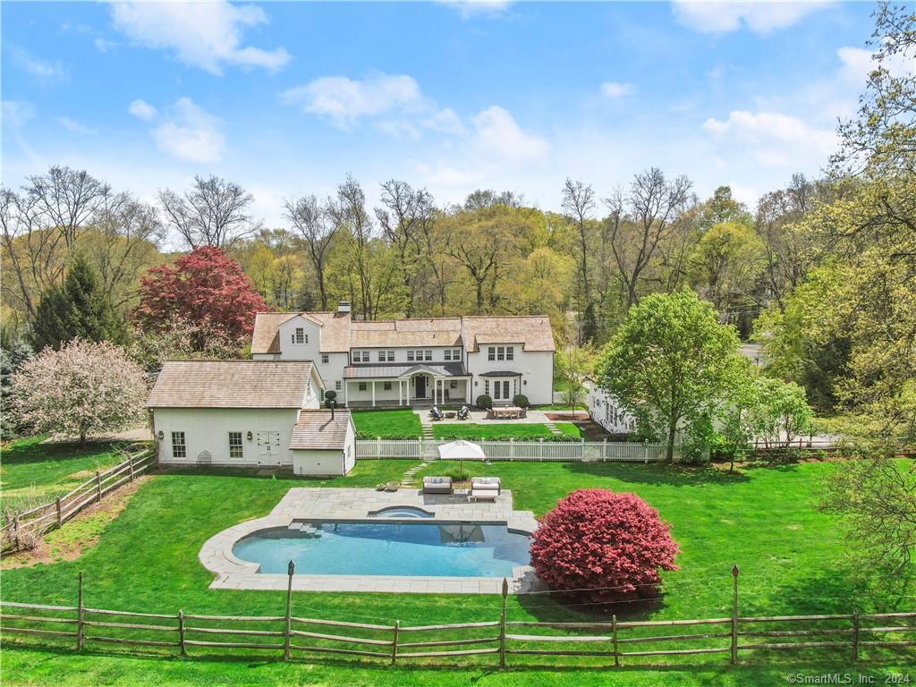 a aerial view of a house with a yard table and chairs
