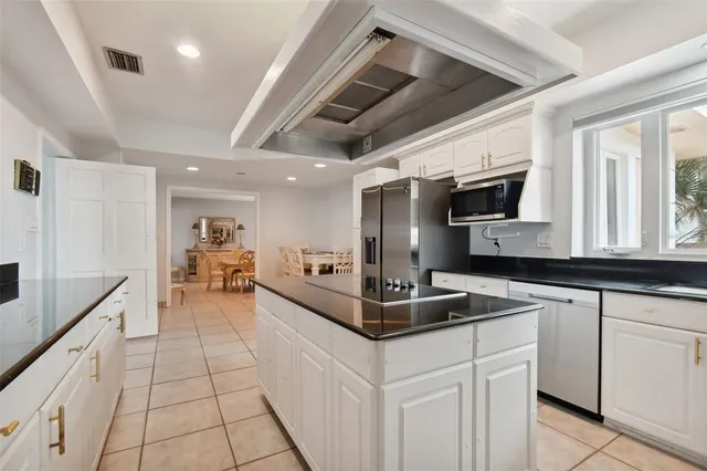 a kitchen with stainless steel appliances granite countertop a sink stove and microwave