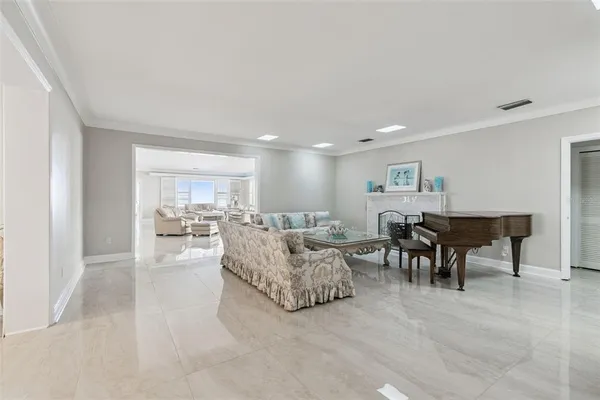 a living room with furniture and a dining table with kitchen view