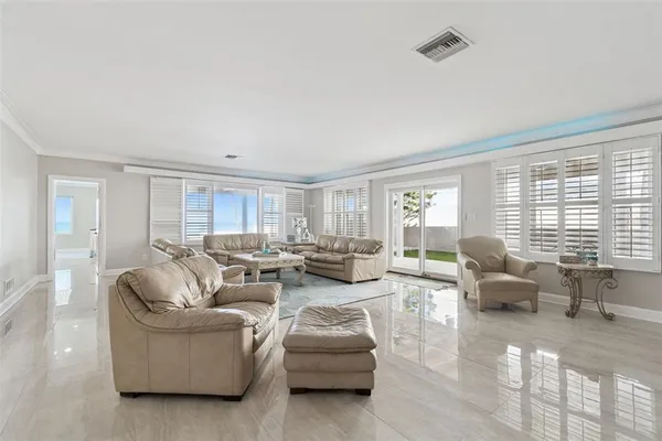 a living room with furniture and large windows