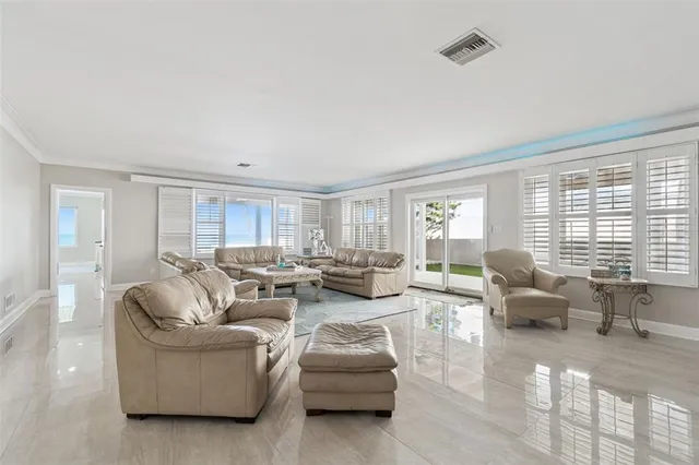 a living room with furniture and large windows