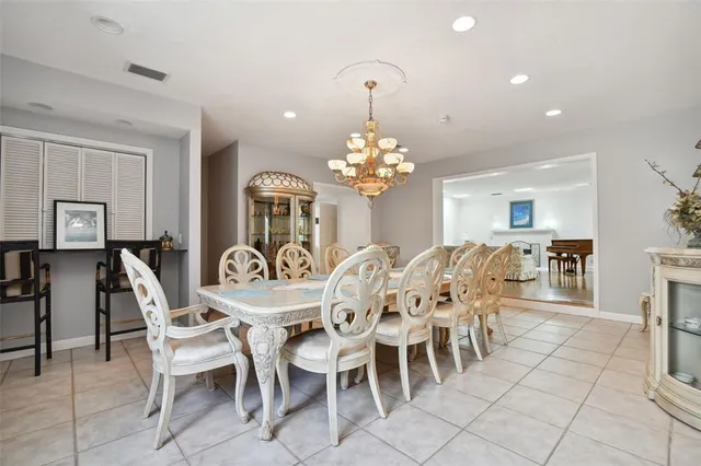 a dining room with furniture and chandelier