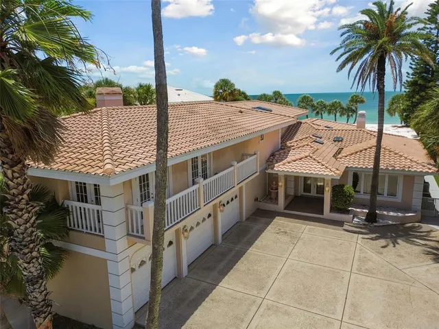 a view of a house with outdoor space and palm trees