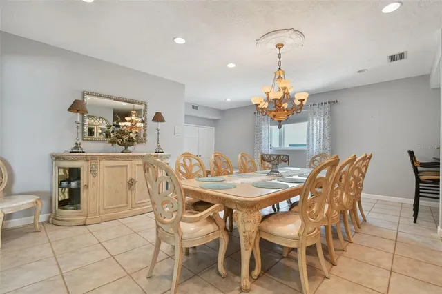 a view of a dining room with furniture and chandelier