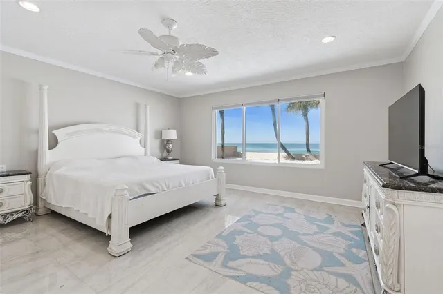 a bedroom with a bed and a flat tv screen on dresser