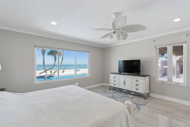 a bedroom with a bed and a ceiling fan