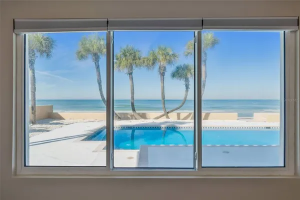 a bedroom with a bed next to a window with a ceiling fan