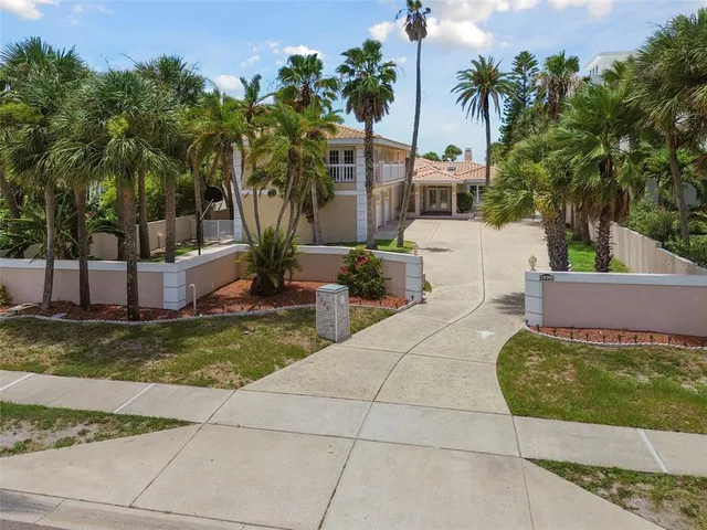 a view of a house with backyard and sitting area