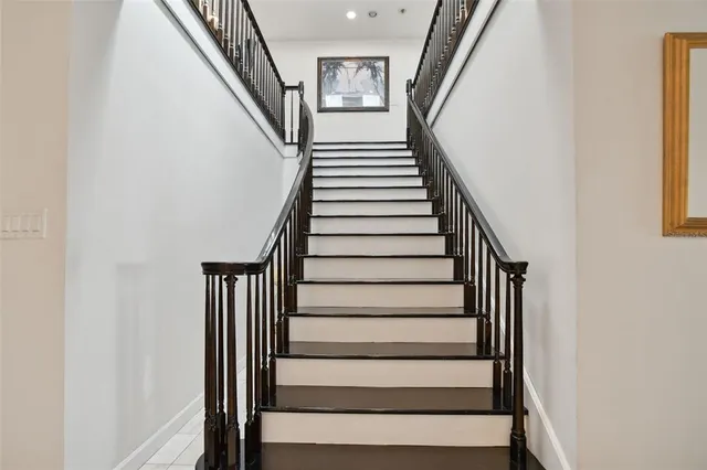 a room with lots of tables a chandelier and pool view