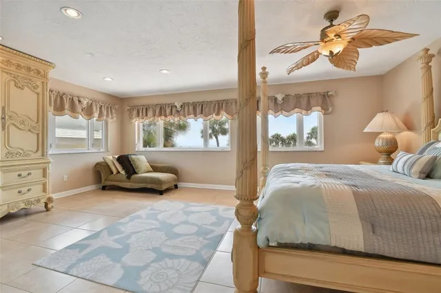 a living room with furniture a chandelier and a floor to ceiling window