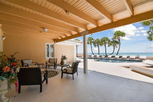 a front view of house with yard and palm tree
