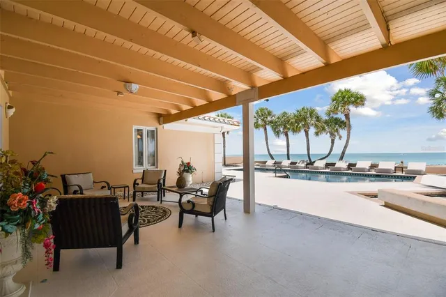 a front view of house with yard and palm tree