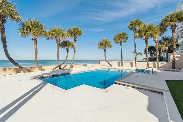 a view of a swimming pool with a yard