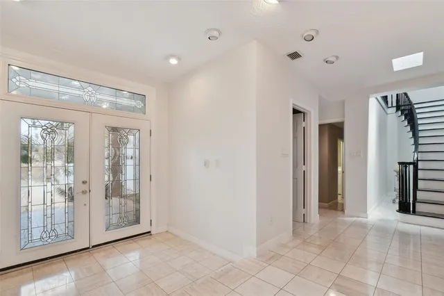 a view of an empty room with glass door