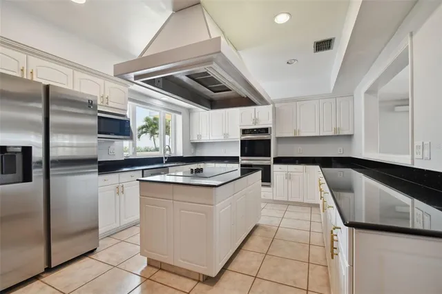 a kitchen with a stove sink and refrigerator