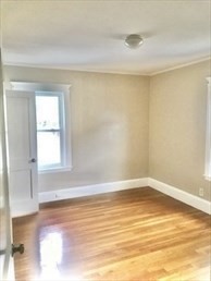 107 Wrentham Street, Unit 2 Boston, MA 02124 - Photo 6 of 11 a view of a room with wooden floor and a window