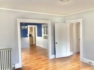 107 Wrentham Street, Unit 2 Boston, MA 02124 - Photo 7 of 11 a view of a hallway with wooden floor and a living room
