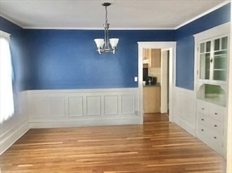 107 Wrentham Street, Unit 2 Boston, MA 02124 - Photo 9 of 11 a view of an empty room with wooden floor and a window