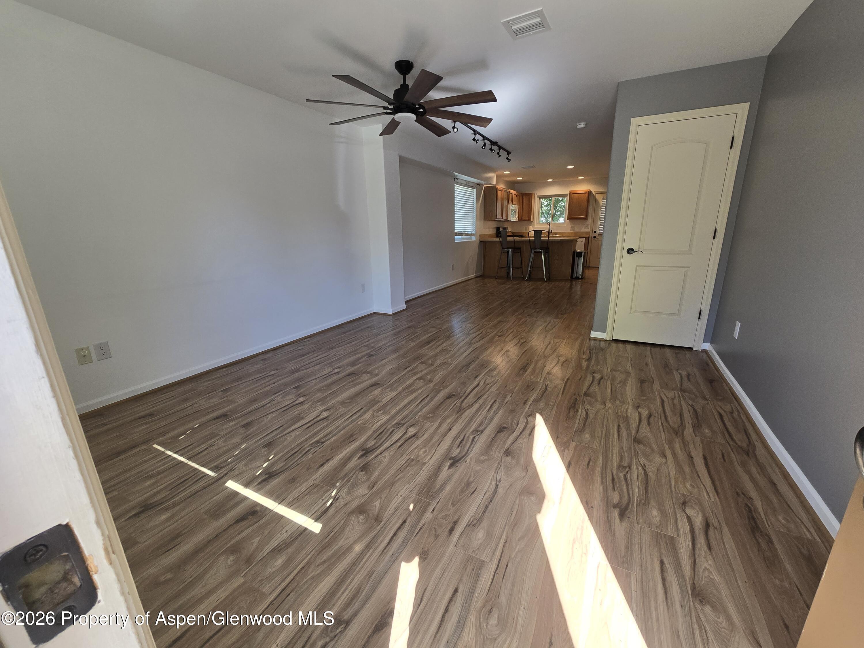 145 West 26th Street Rifle, CO 81650 - Photo 2 of 7 a view of empty room with wooden floor