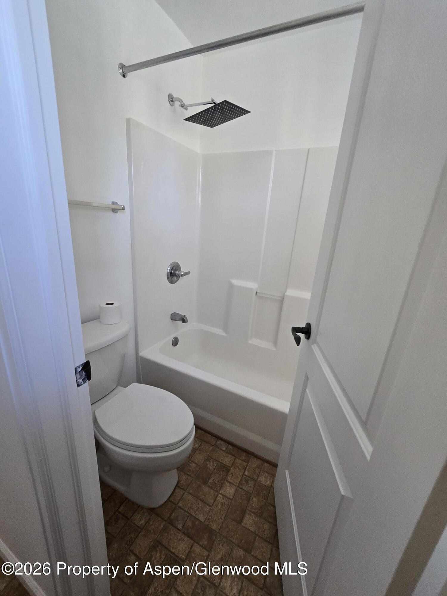 145 West 26th Street Rifle, CO 81650 - Photo 6 of 7 a bathroom with a toilet and a shower
