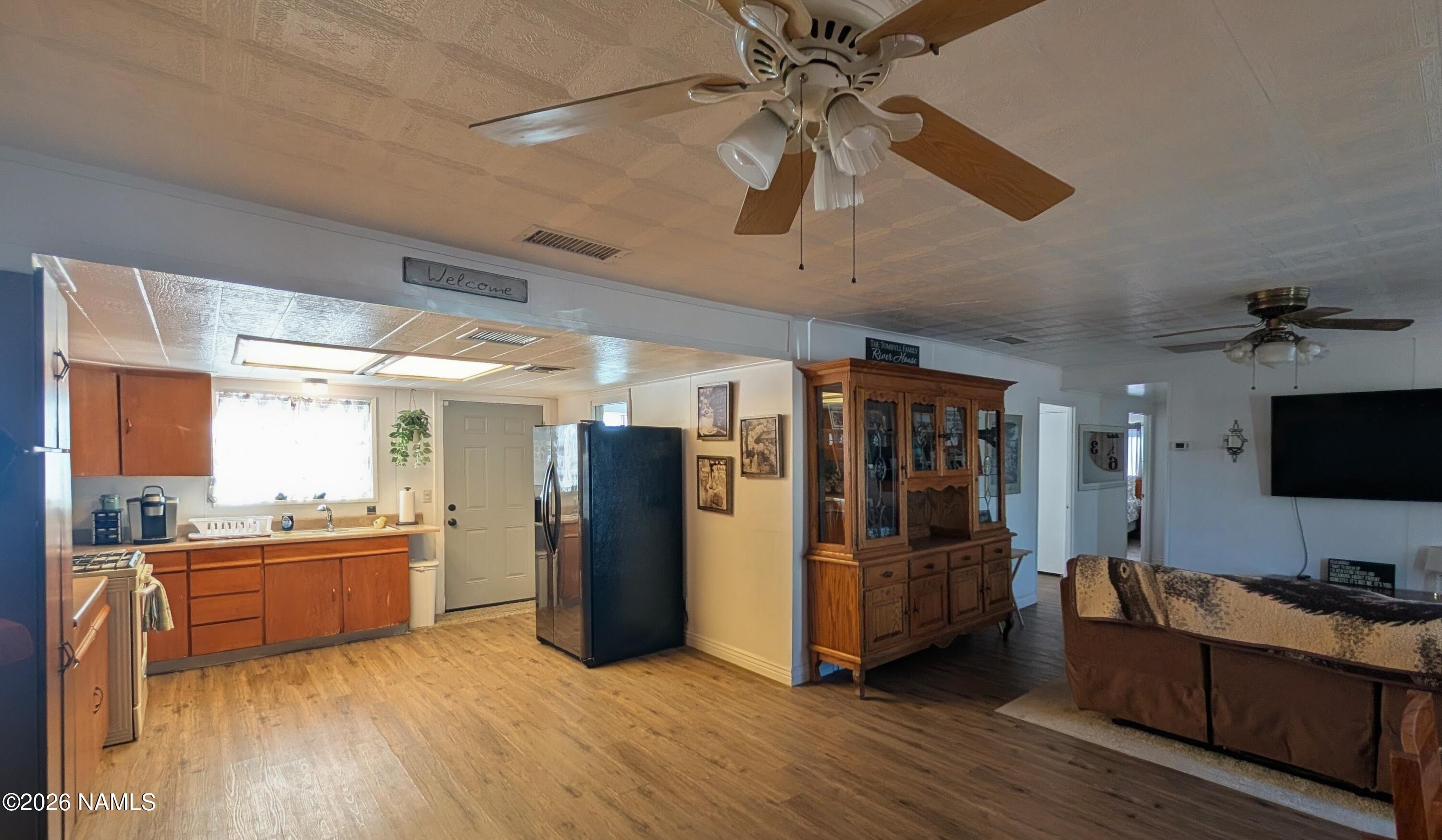 15702 Bonanza Loop Ehrenberg, AZ 85334 - Photo 2 of 13 a view of a kitchen with a refrigerator microwave and a sink
