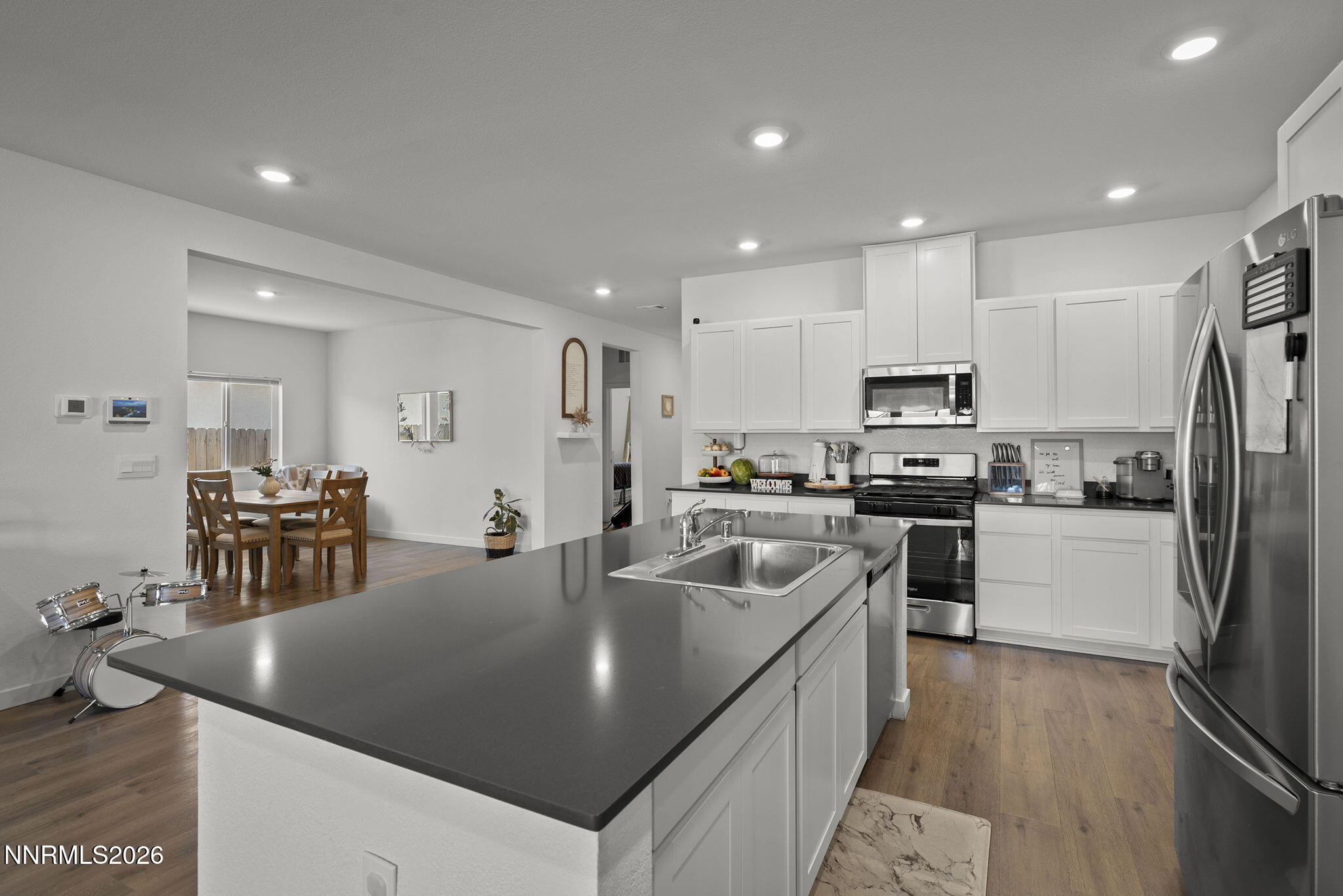 738 Butte Creek Road Dayton, NV 89403 - Photo 5 of 28 a kitchen with stainless steel appliances granite countertop a refrigerator a oven a sink a stove and white cabinets