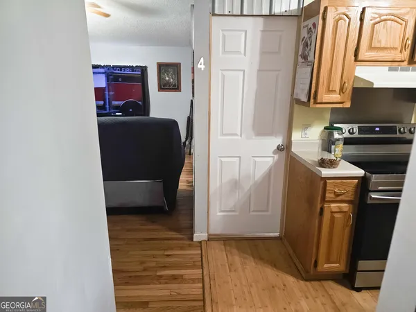 a kitchen with stainless steel appliances granite countertop a refrigerator a stove and a sink