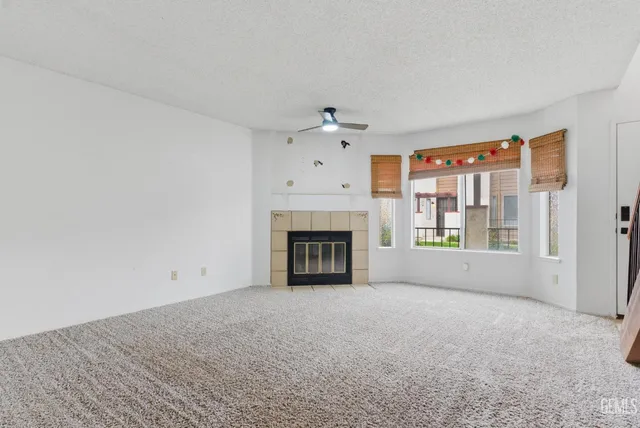 a view of an empty room with a fireplace