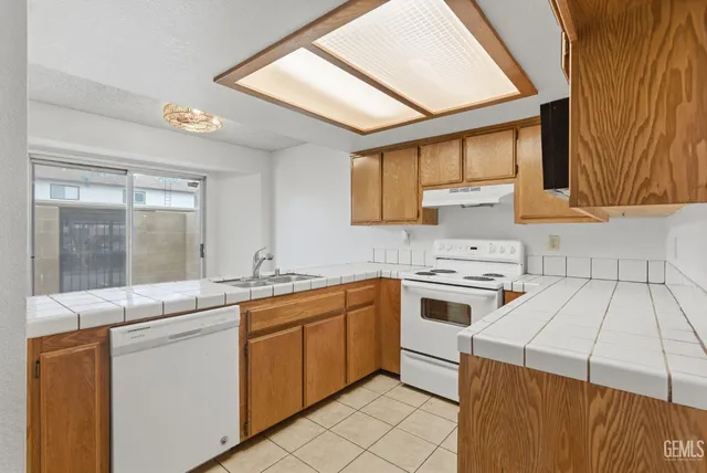 a kitchen with a sink stove and cabinets