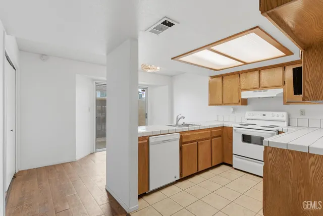 a kitchen with stainless steel appliances granite countertop a sink and cabinets