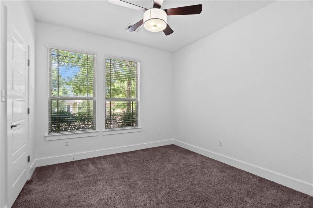 1765 Rowdy Loop, Unit 47 Leander, TX 78641 - Photo 30 of 40 Plush carpeting and dual windows overlooking the yard define this versatile secondary bedroom.