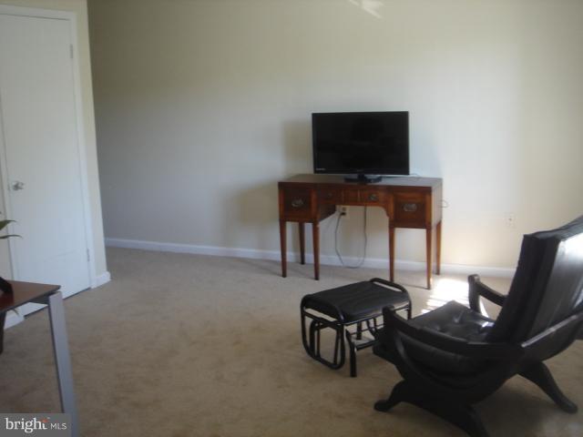 21 Hamill Road, Unit 21F Baltimore, MD 21210 - Photo 14 of 28 a living room with furniture and a flat screen tv