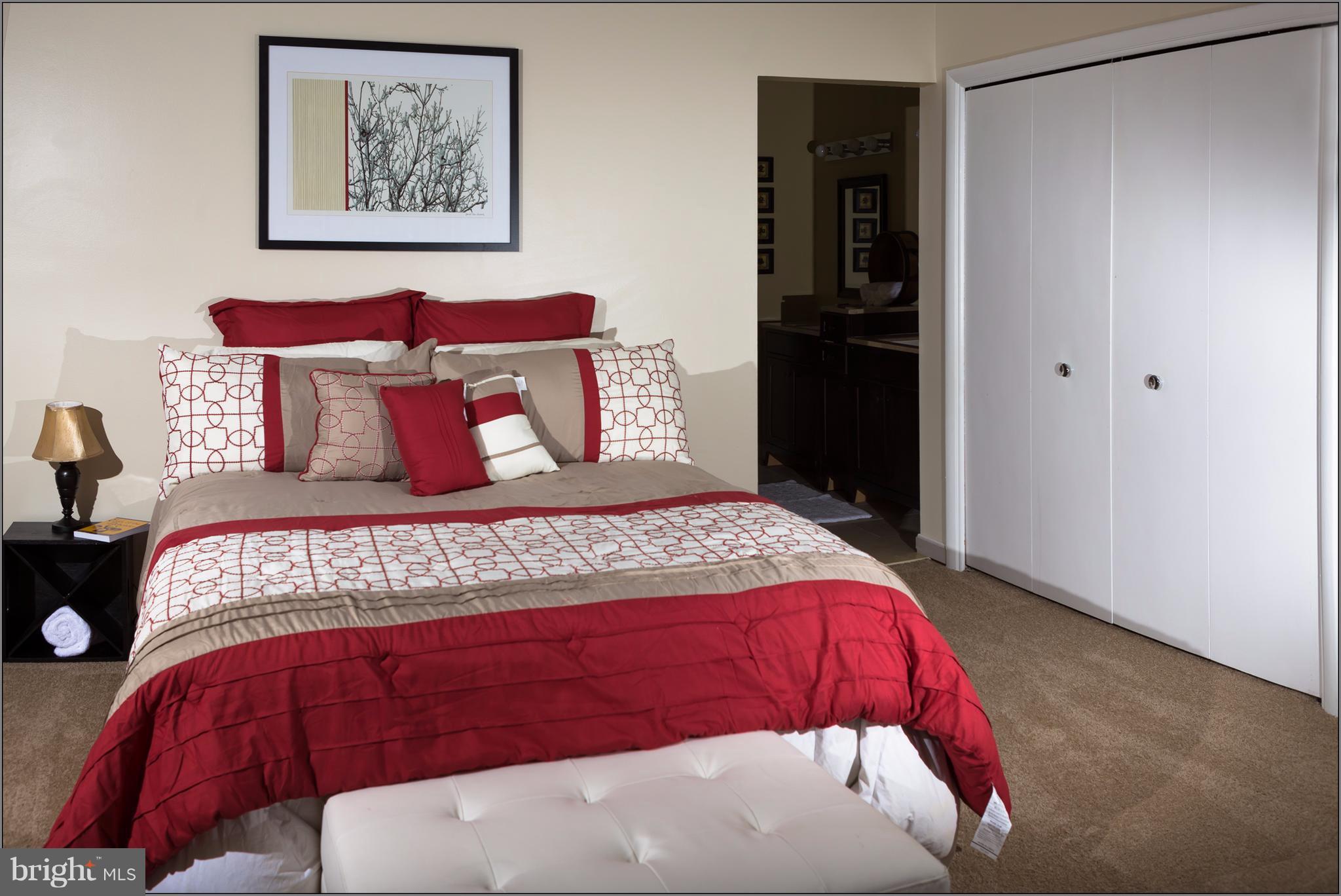 21 Hamill Road, Unit 21F Baltimore, MD 21210 - Photo 9 of 28 a bedroom with a bed and wall painting