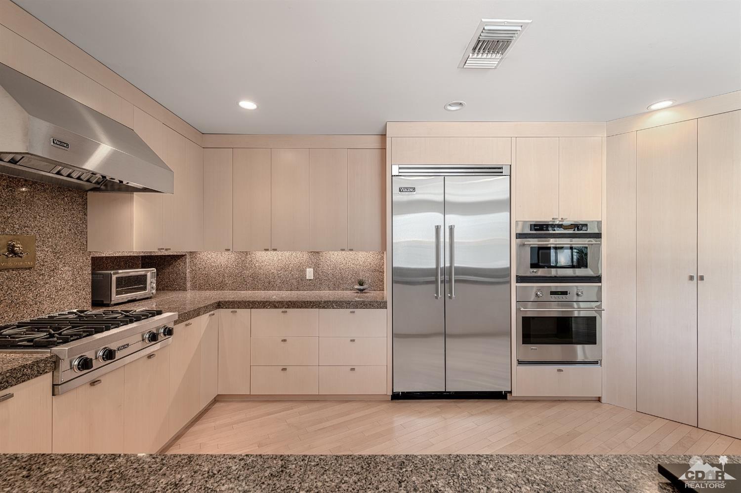 37490 Palm View Road Rancho Mirage, CA 92270 - Photo 22 of 63 a kitchen with stainless steel appliances kitchen island granite countertop a refrigerator and a stove