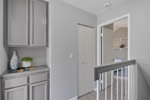 a view of kitchen with granite countertop cabinets