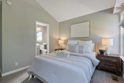 a bedroom with a bed and a night stand