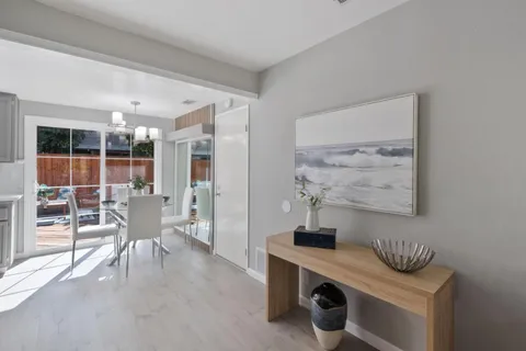 a dining room with furniture and a window