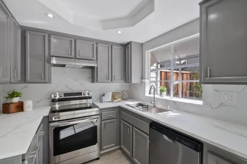 a kitchen with a sink stove and cabinets