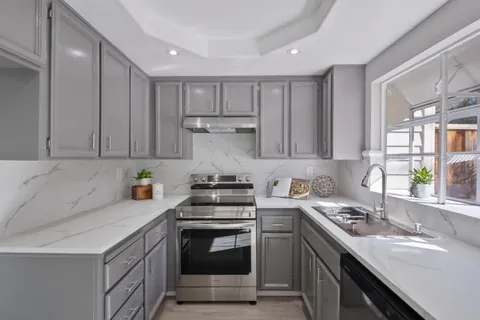 a kitchen with a sink stove and cabinets