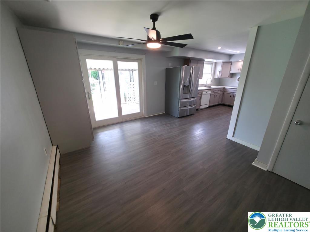 719 Keystone Avenue Bethlehem, PA 18018 - Photo 10 of 32 Sliding doors invite natural light into this combined living area with sleek flooring and a contemporary kitchen.