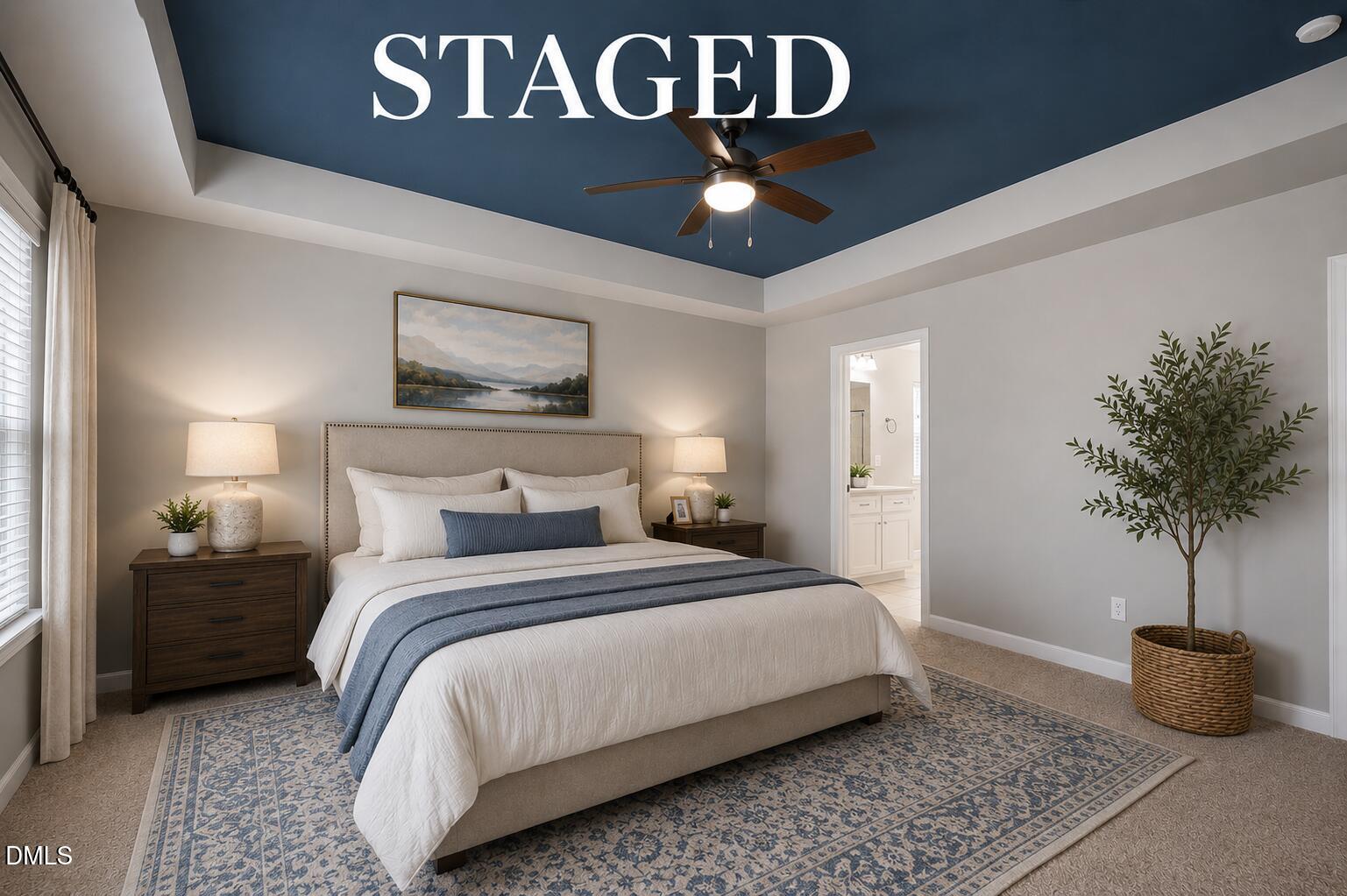 364 Springtime Fields Lane Wake Forest, NC 27587 - Photo 32 of 63 a bedroom with a large bed and a chandelier