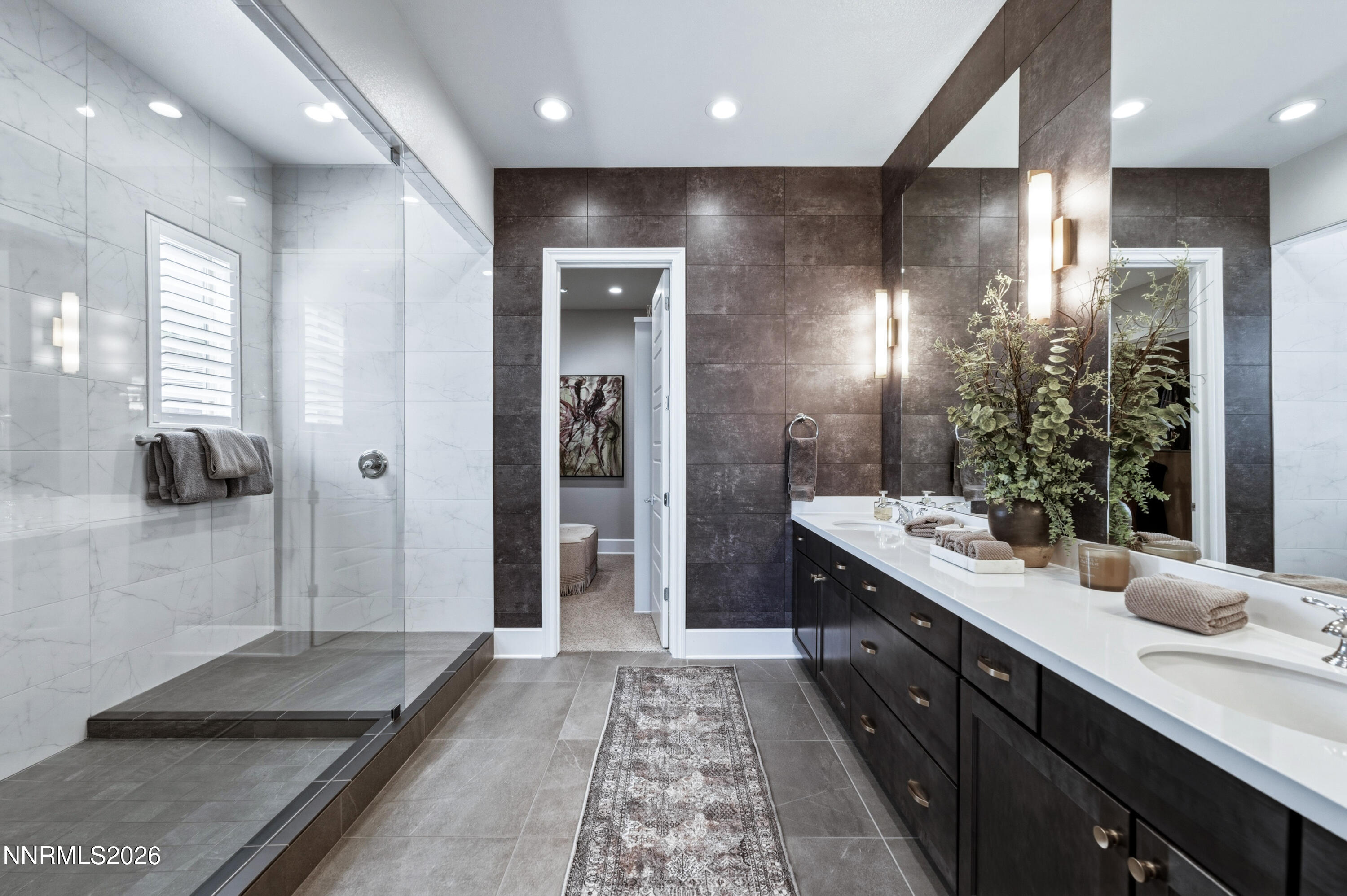 9028 Iron Sky Court Reno, NV 89523 - Photo 13 of 36 a bathroom with a double vanity sink and a mirror