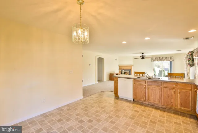 a kitchen with stainless steel appliances granite countertop a sink and dishwasher with white cabinets