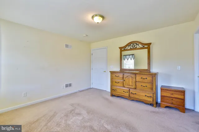 a room with furniture and a dresser