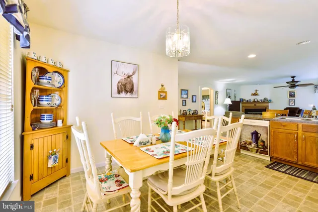 a view of a dining room with furniture and chandelier