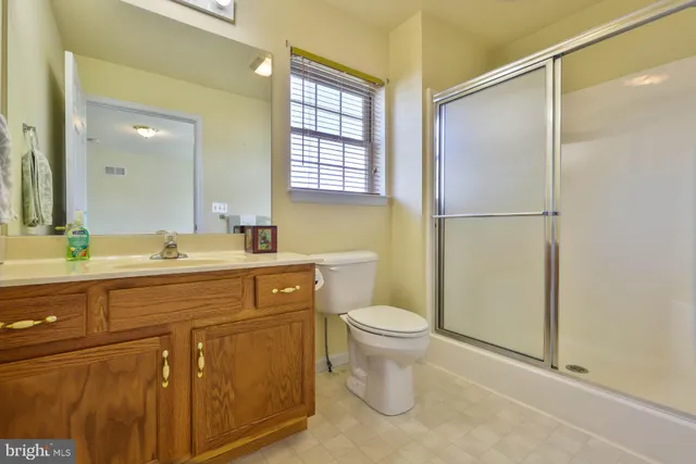 a spacious bathroom with a sink toilet and shower