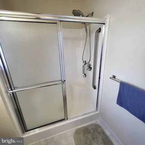 a bathroom with a glass shower door